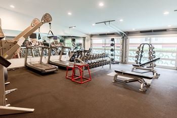 a gym with weights and cardio equipment on the floor and a window at Notch 8, Tacoma, WA